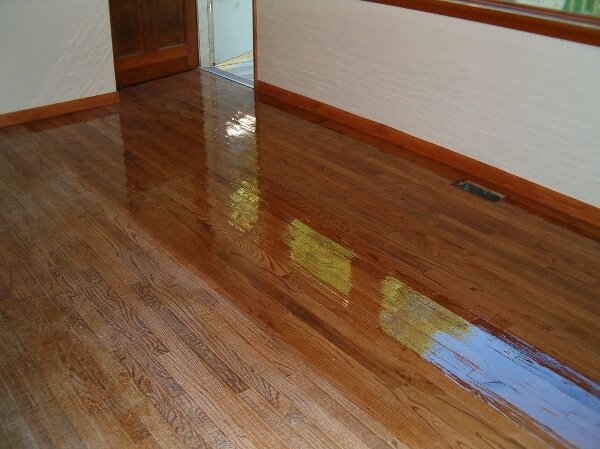 a hardwood floor in the middle of being resurfaced